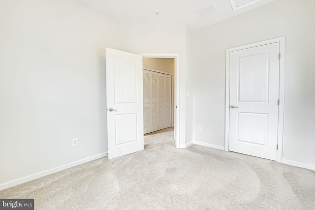 unfurnished bedroom featuring light carpet