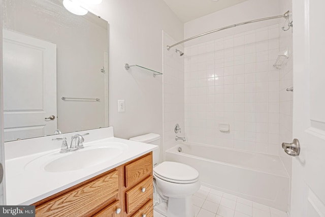 full bathroom featuring tile patterned floors, tiled shower / bath, vanity, and toilet