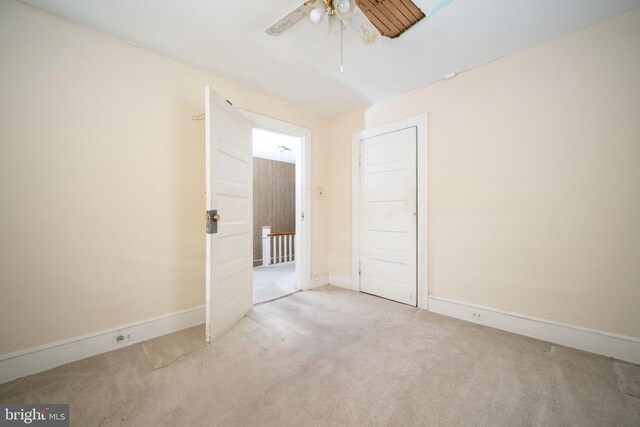 spare room with light carpet and ceiling fan