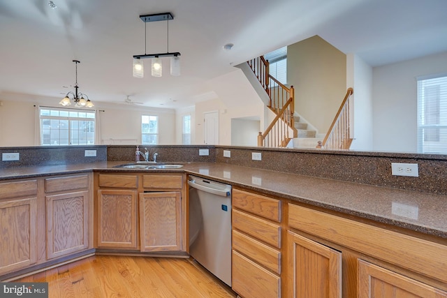 kitchen with ceiling fan with notable chandelier, pendant lighting, sink, light wood-type flooring, and stainless steel dishwasher