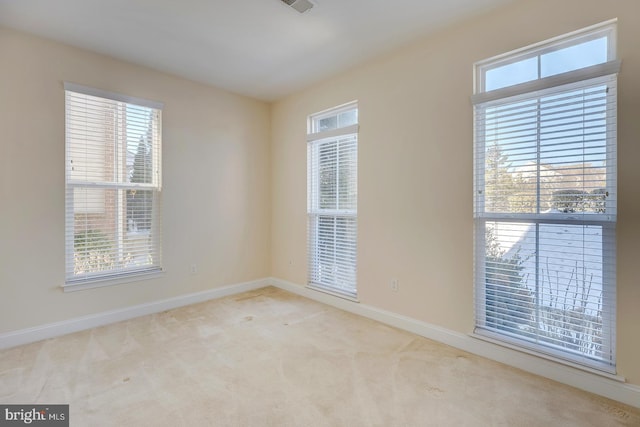 spare room with light colored carpet