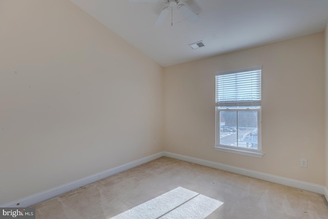 spare room featuring ceiling fan and light colored carpet