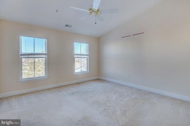 unfurnished room featuring vaulted ceiling, ceiling fan, and light colored carpet