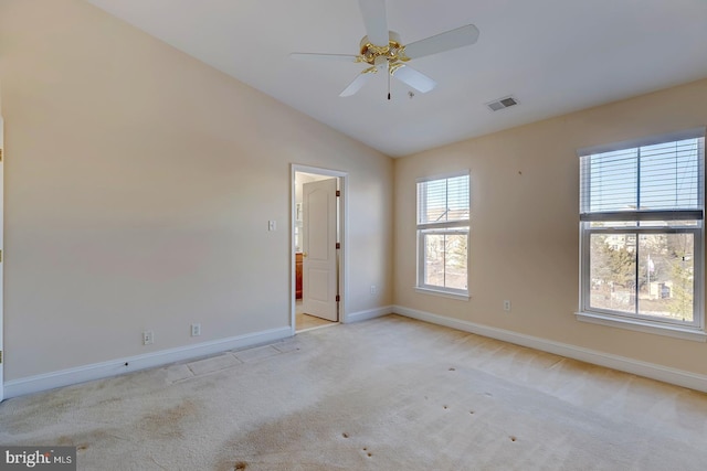 carpeted empty room featuring ceiling fan and vaulted ceiling