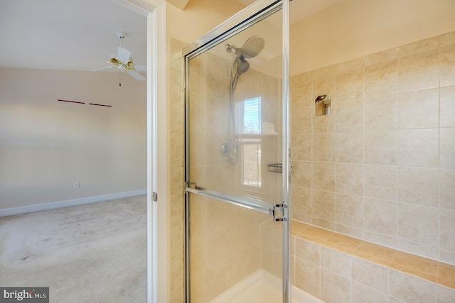 bathroom featuring ceiling fan and a shower with door