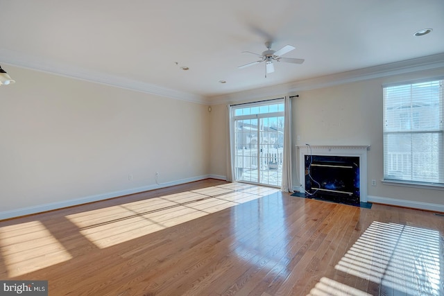 unfurnished living room featuring light wood-type flooring, ceiling fan, and crown molding