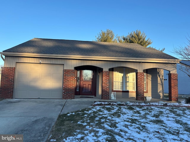 ranch-style house with a porch and a garage