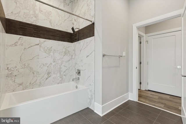 bathroom with shower / washtub combination and baseboards