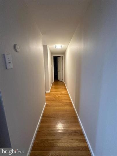 hallway with light hardwood / wood-style flooring