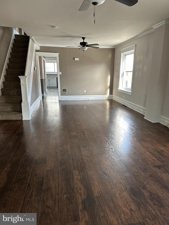 unfurnished living room with ornamental molding, ceiling fan, and dark wood-type flooring