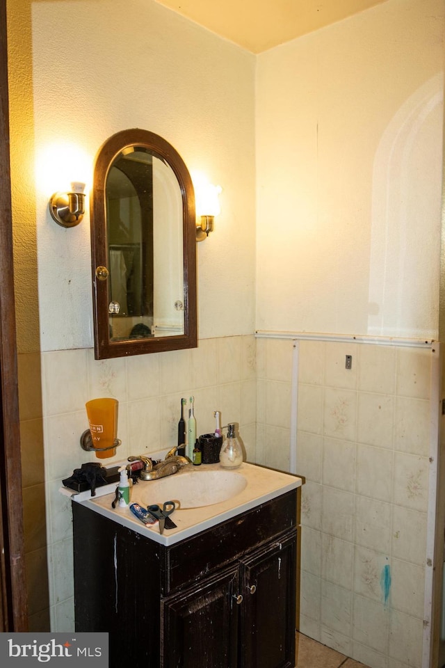 bathroom featuring vanity, tile walls, and backsplash