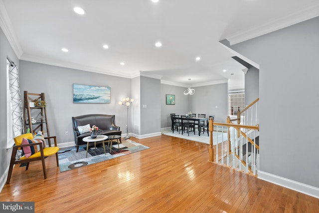 sitting room featuring ornamental molding and light hardwood / wood-style floors