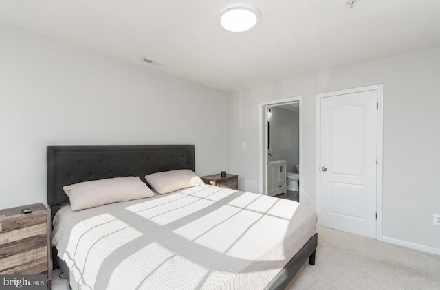 bedroom with carpet flooring and ensuite bathroom