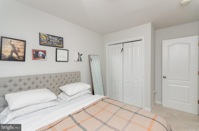 bedroom featuring a closet and light colored carpet