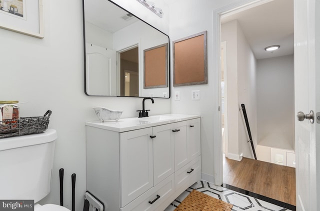 bathroom with vanity and toilet