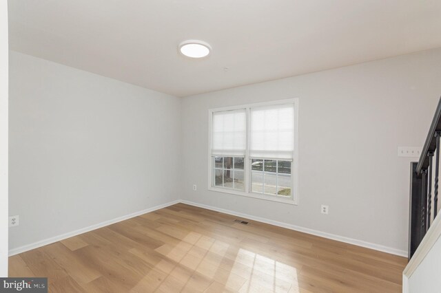 unfurnished room with light hardwood / wood-style floors