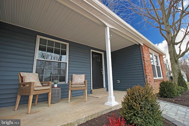 view of exterior entry featuring a porch