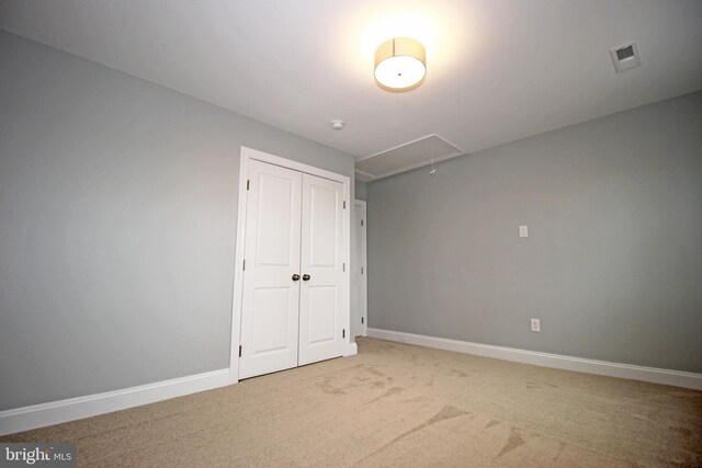 unfurnished bedroom with a closet and carpet