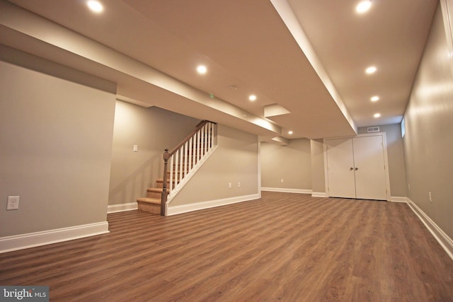 basement with dark hardwood / wood-style floors