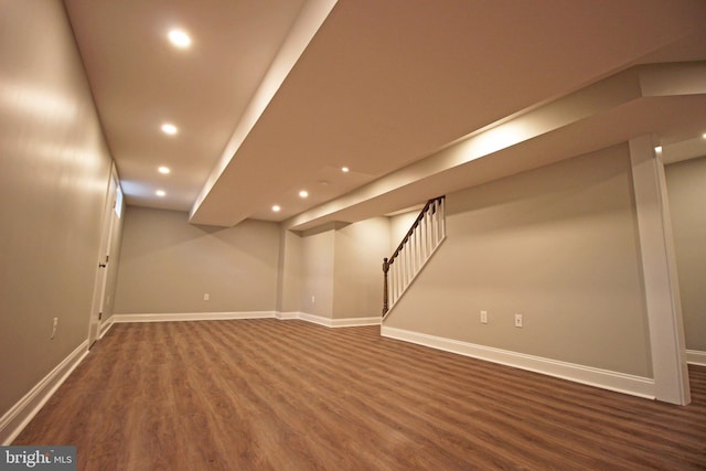 basement with dark hardwood / wood-style floors