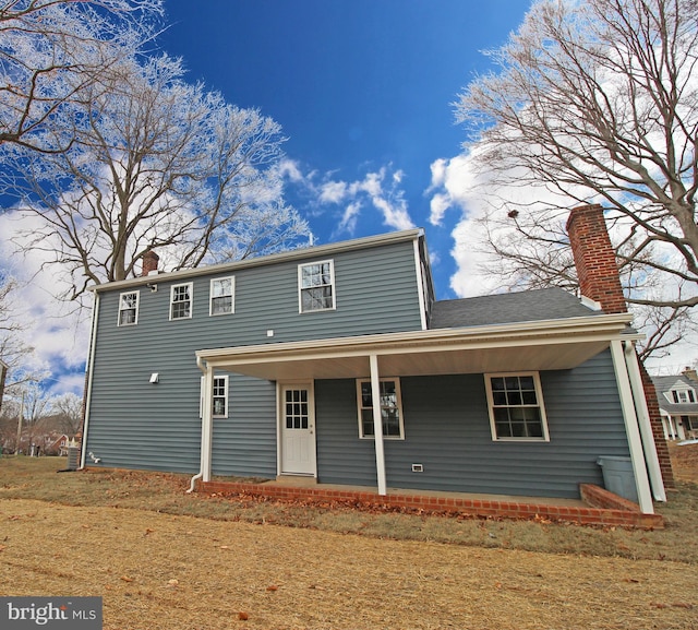 back of house with a lawn