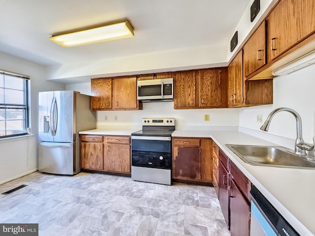 kitchen with sink and appliances with stainless steel finishes