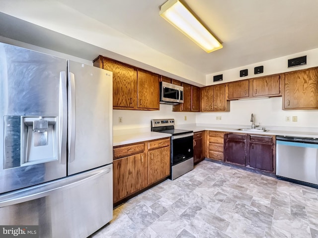 kitchen with sink and appliances with stainless steel finishes