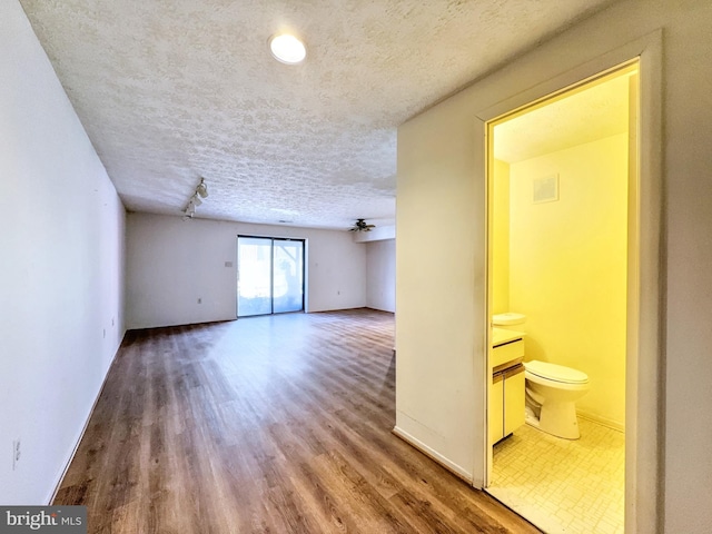 spare room featuring hardwood / wood-style floors, a textured ceiling, and ceiling fan