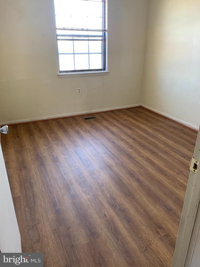 empty room featuring dark wood-type flooring