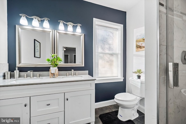 bathroom featuring vanity, toilet, and an enclosed shower