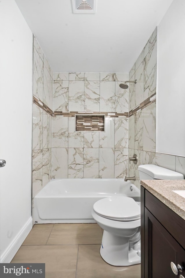 full bathroom with tile patterned floors, toilet, vanity, tile walls, and tiled shower / bath