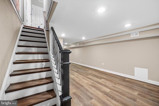 stairs with hardwood / wood-style flooring