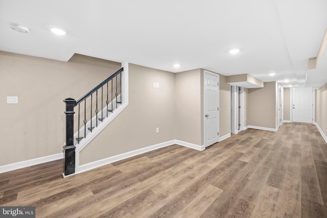 basement with hardwood / wood-style floors