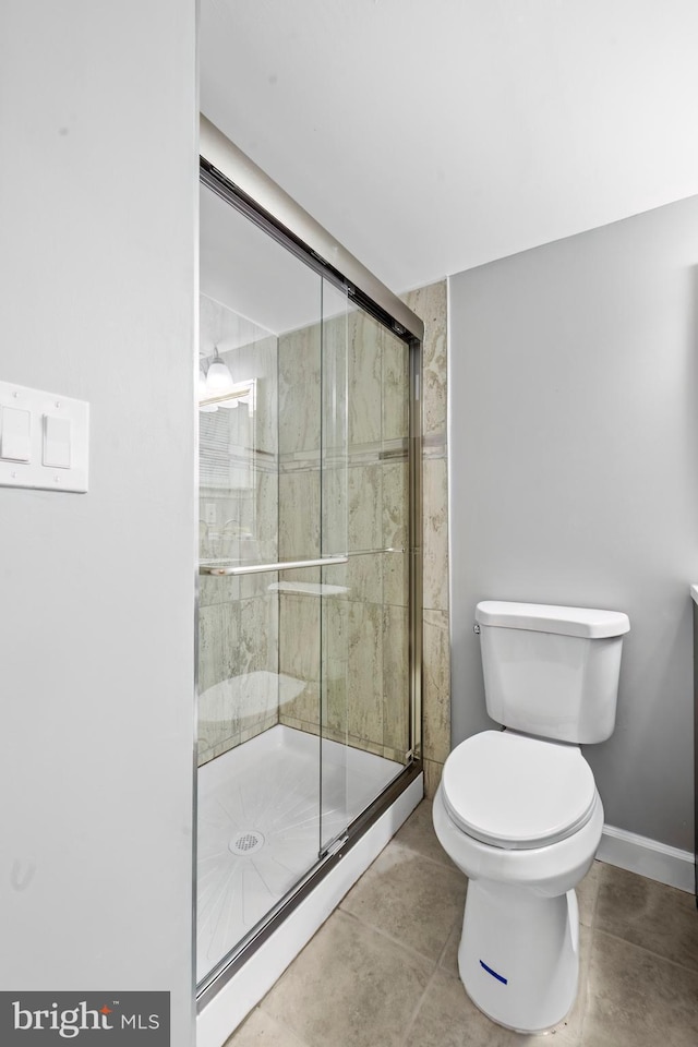 bathroom featuring toilet and walk in shower