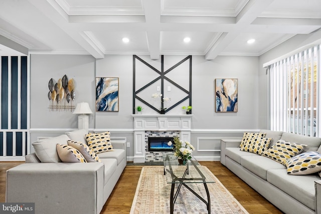 living room featuring hardwood / wood-style flooring, beamed ceiling, coffered ceiling, and ornamental molding