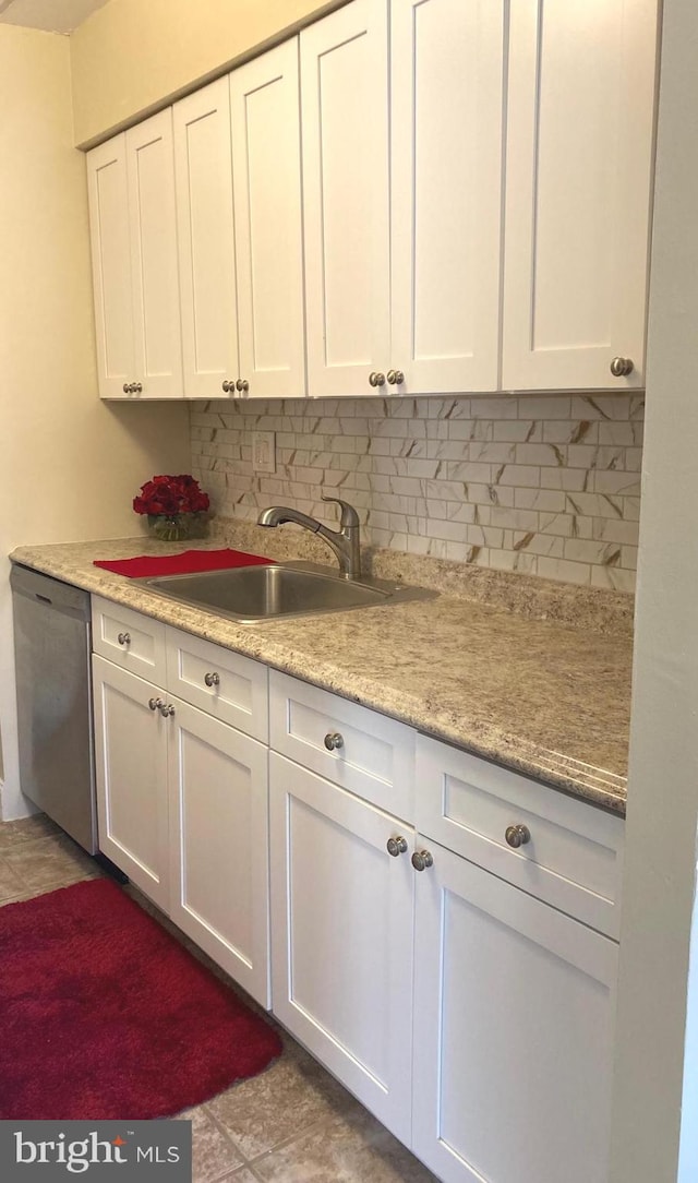 kitchen with white cabinetry, sink, and stainless steel dishwasher