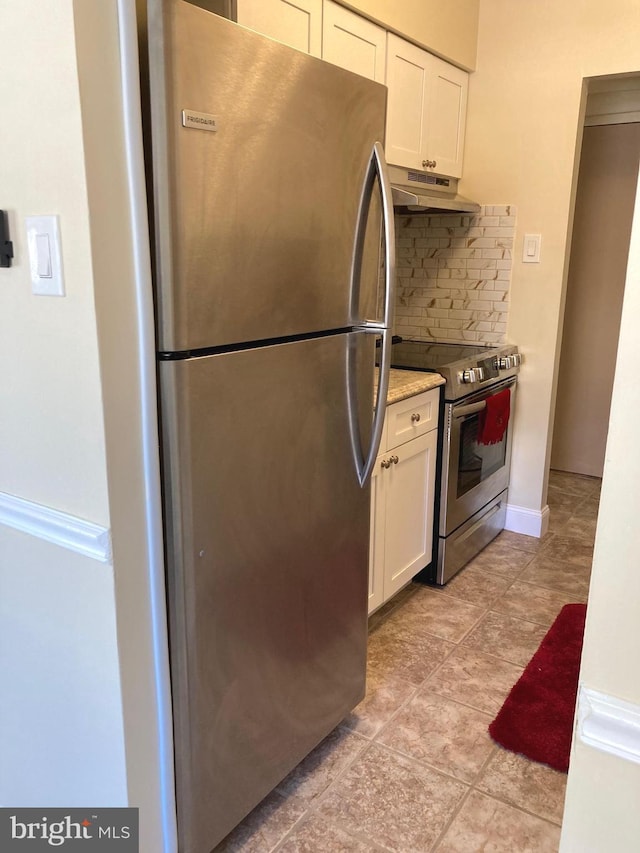 kitchen featuring backsplash, light stone countertops, white cabinets, and stainless steel appliances