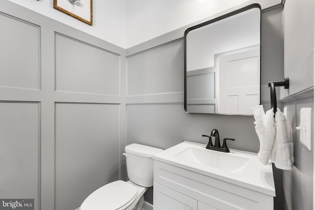 bathroom with toilet and vanity