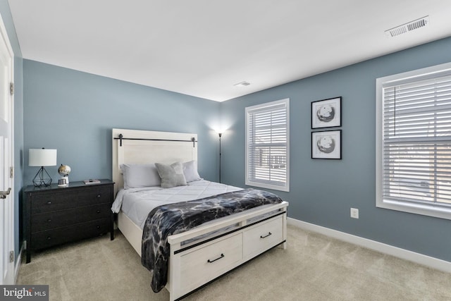 bedroom featuring light colored carpet