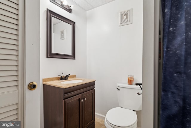 bathroom with tile patterned floors, vanity, and toilet