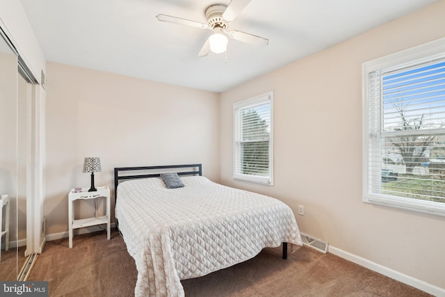 carpeted bedroom with ceiling fan and a closet