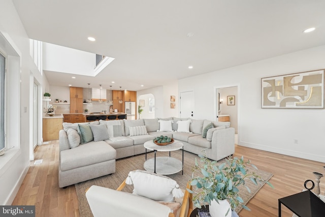 living room featuring plenty of natural light and light hardwood / wood-style flooring