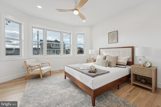 bedroom with ceiling fan and light wood-type flooring