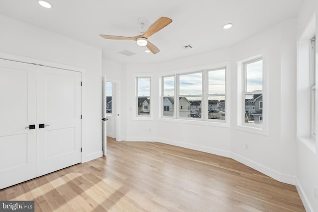 interior space with ceiling fan, a closet, and light wood-type flooring