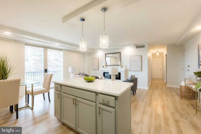 kitchen featuring a kitchen island, hanging light fixtures, and light wood-type flooring