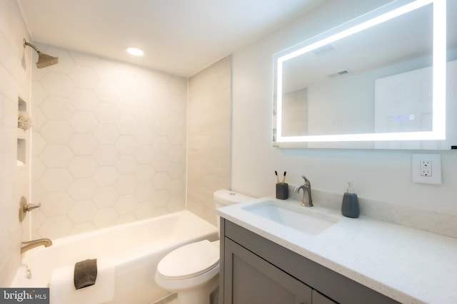 full bathroom featuring vanity, toilet, and tiled shower / bath