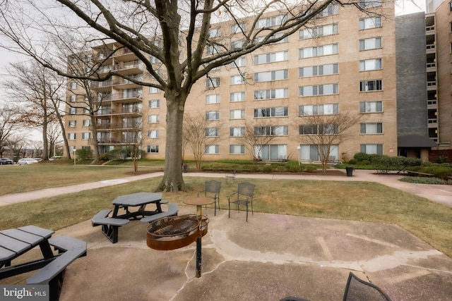 view of home's community featuring a lawn and a patio