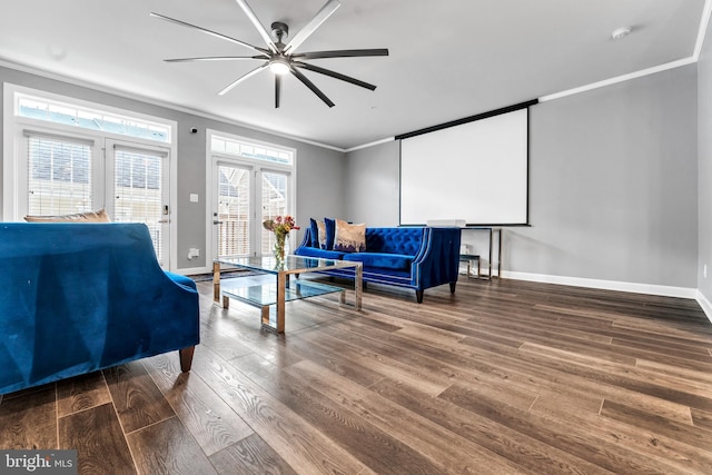 living area featuring hardwood / wood-style floors, ceiling fan, and crown molding