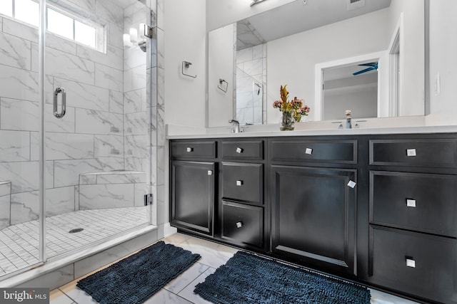 bathroom featuring vanity and a shower with shower door