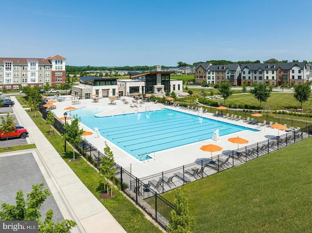 view of swimming pool with a lawn and a patio area